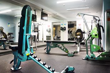 Fitness center with weight lifting machines at Surrey Village in Surrey, BC
